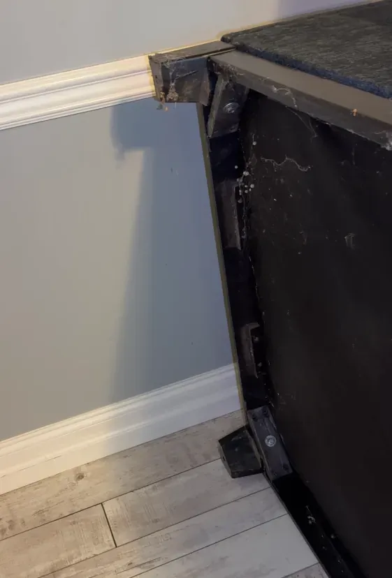 Sectional sofa tipped on its side to expose the underside during a deep clean