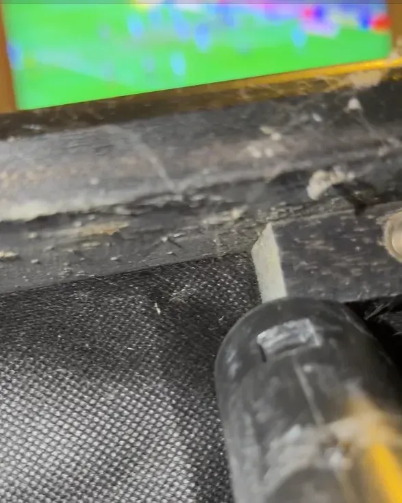 Sofa frame rail after vacuuming — clean, no debris